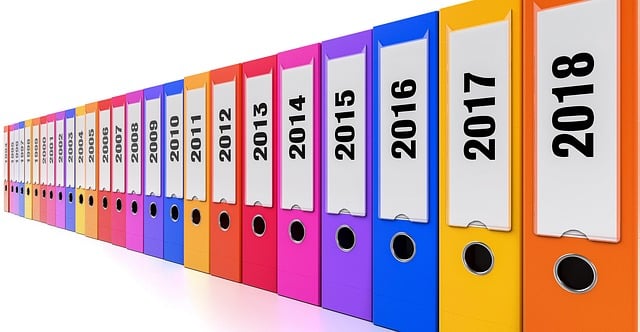 colorful binders with spines visible, years showing